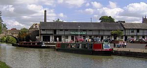 Water with two narrow boats and bridge