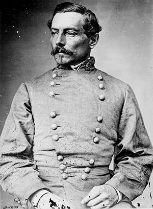 Head and torso photograph of a high ranking Confederate army officer. He has short dark hair, a mustache, and small goatee