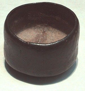 Photo of a tea bowl, dark-coloured, humble, and asymmetric.