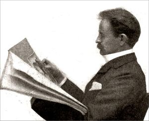 A Victorian man of middle age, with a moustache, seated, reading a newspaper, viewed in profile from his left