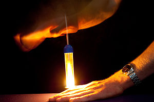 A piece of flash cotton is ignited by the sudden compression of a fire piston.