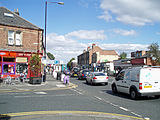 A busy road with shops on both sides