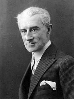 Clean shaven white man with full head of white or grey hair, elegantly dressed