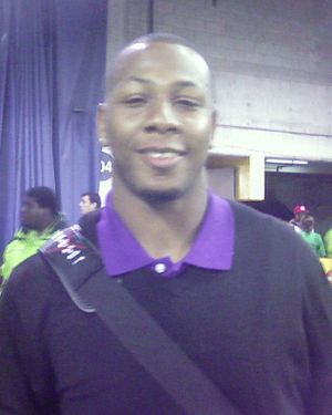 An American football player wearing a baby blue jersey with the number 81 across the chest and black cap on his head