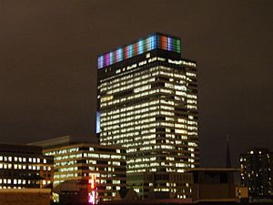 Target tower lit at night in a rainbow at the top