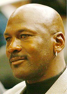 Head shot of a bald black man looking left