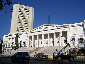 A white building with a triangular façade and wide stairs