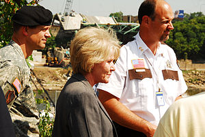 Mary Peters and escort and Sheriff Richard Stanek looking