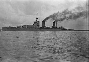 Three-stacked, dark grey warship at sea