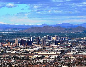 A photo showing the skyline of Phoenix, looking north.  It shows the various buildings of the downtown area, as well as Sunnyslope Mountain in the background