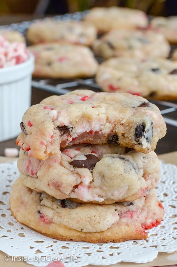 Three Oreo peppermint crunch cookies stacked on top of each other with more cookies behind it