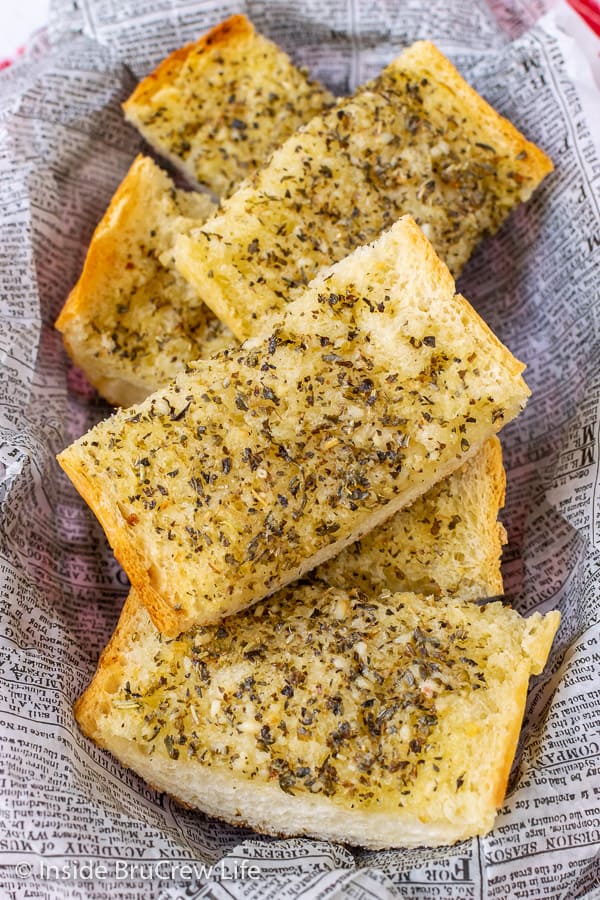 Easy Garlic Herb Bread - a mixture of butter, garlic, and herbs spread on French bread makes a delicious addition to any dinner. Make this easy recipe right before dinner or make it ahead of time and freeze it for later.