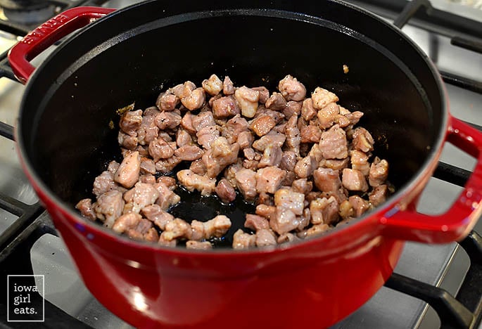 pork shoulder searing in a dutch oven