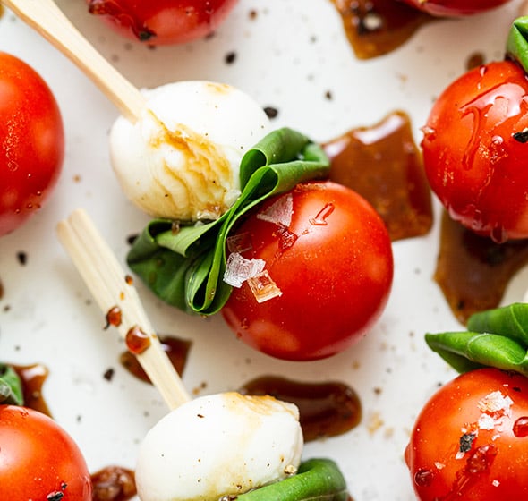 caprese skewer with balsamic drizzle on a serving platter