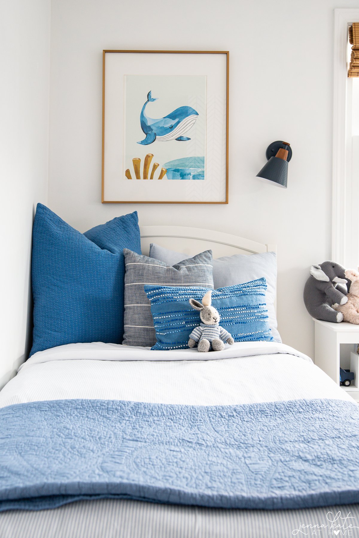 twin bed with blue throw pillows