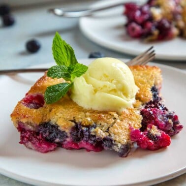 slice of fruit dessert topped with scoop of vanilla ice cream