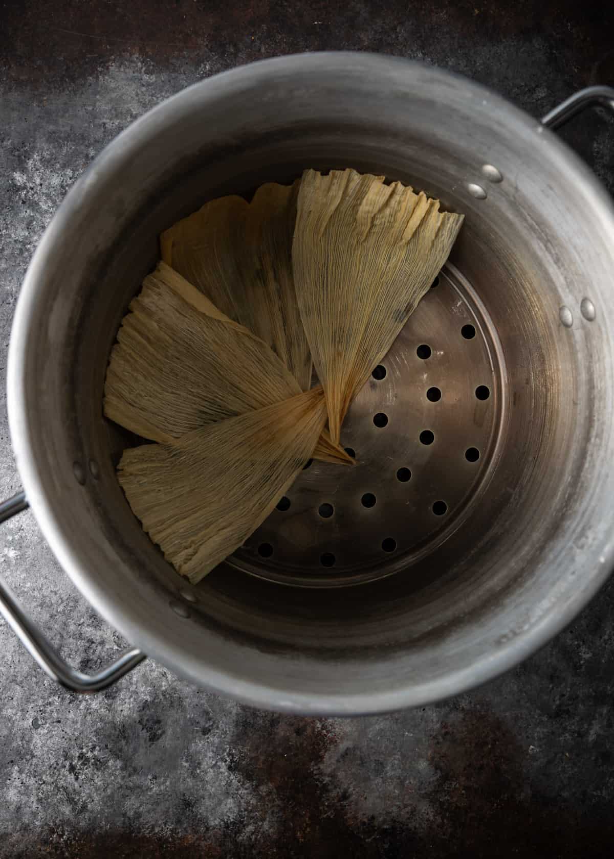 overhead: layering the bottom of a steamer with husks