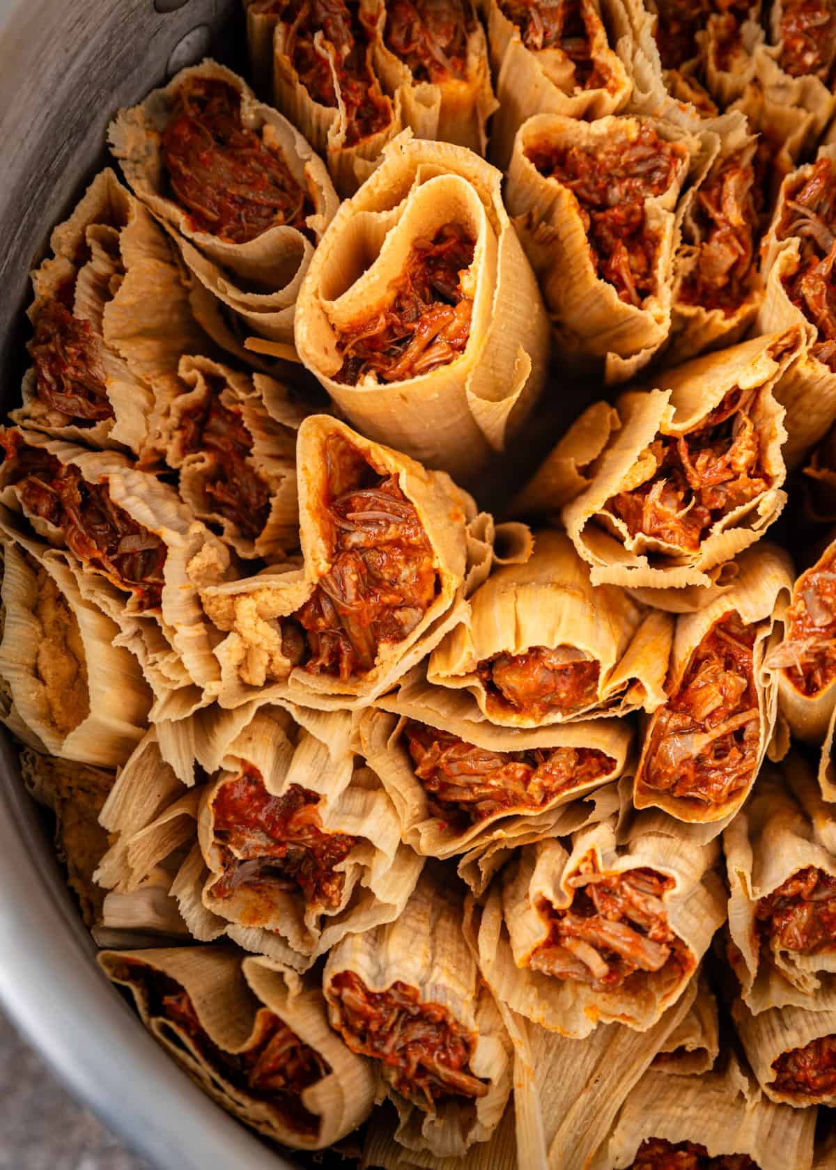 overhead closeup: tamales rojo in a steamer