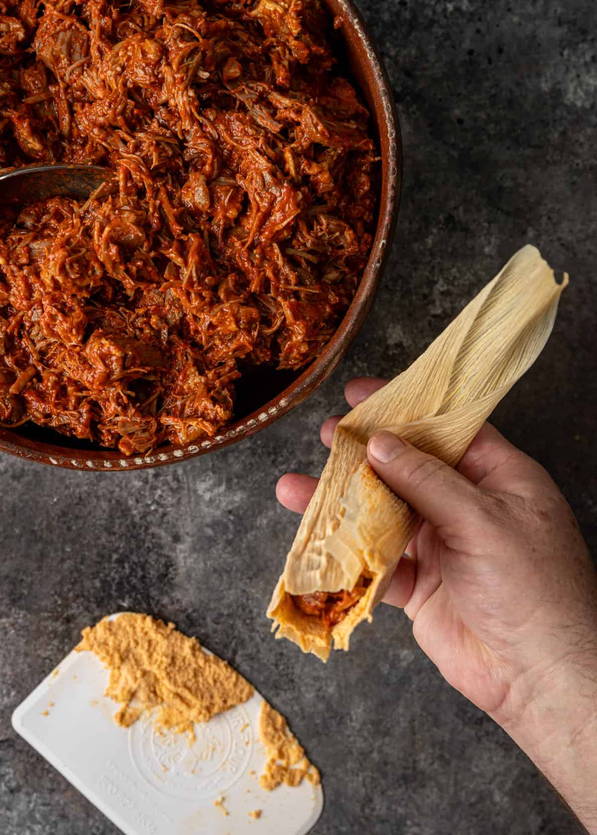 overhead: bending the lower tip end of the pork tamales