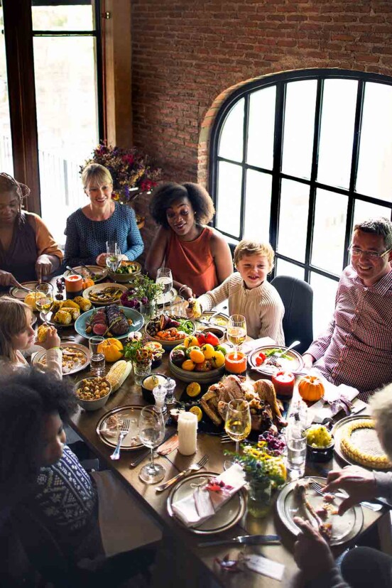 People gathered around a Thanksgiving table