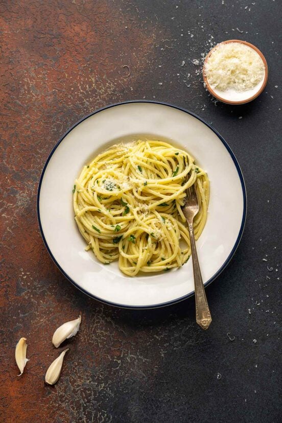 A plate filled with pasta with butter and Parmesan.