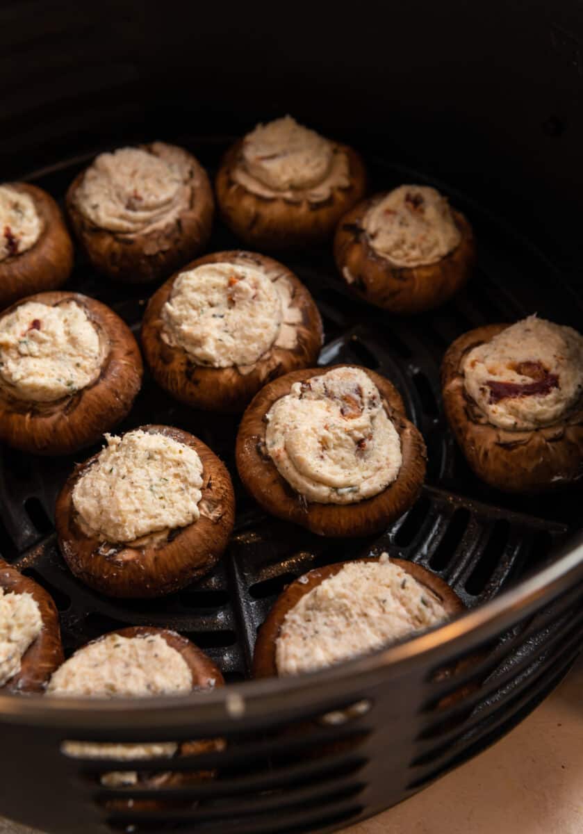 Stuffed mushrooms in air fryer before cooked.