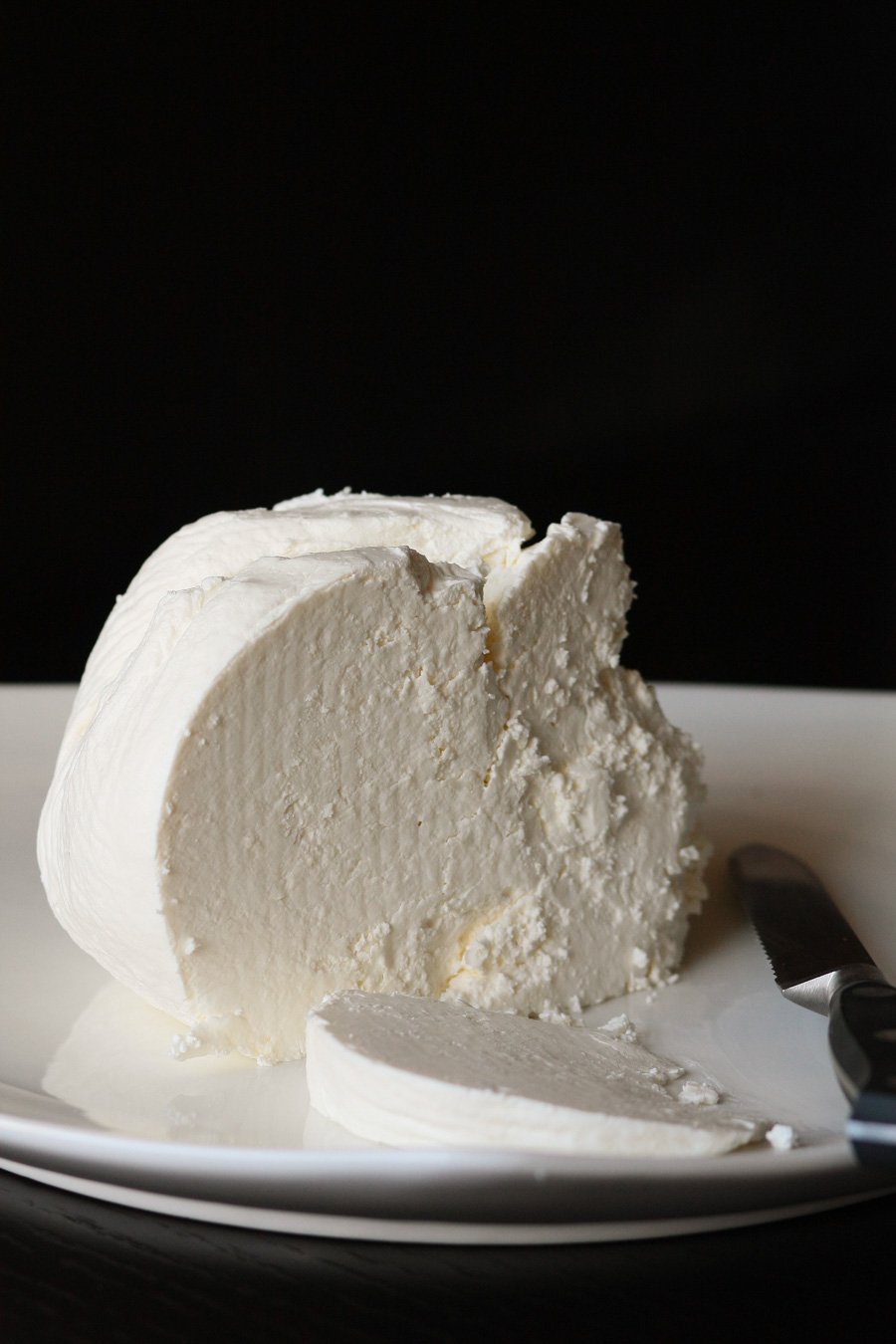 Homemade Farmer’s cheese recipe on a plate with a butter knife. 