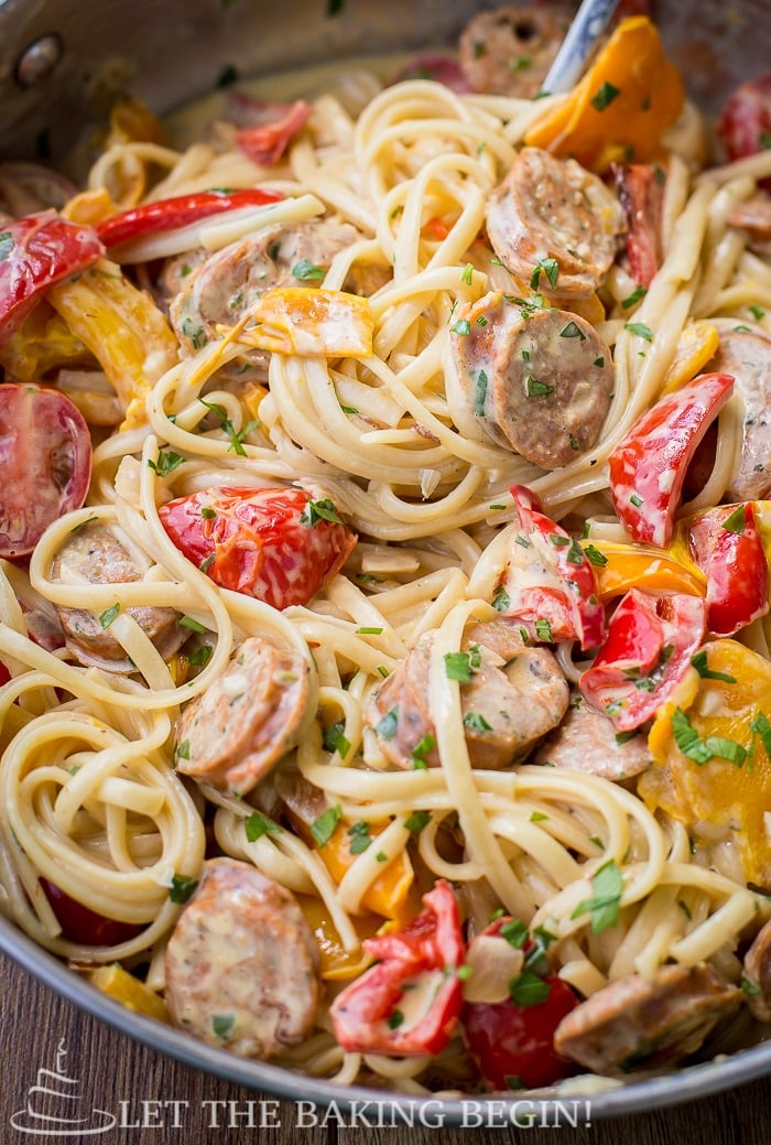 Sausage pepper fettuccine mixed together in a skillet.