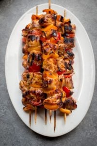 Bacon Wrapped Pork Kabobs - Juicy Kabobs are made even more amazing with the addition of smoky bacon. They're perfect for a summer picnic BBQ. Even you'll be surprised at the amount of flavor packed into these Grilled Kabobs!