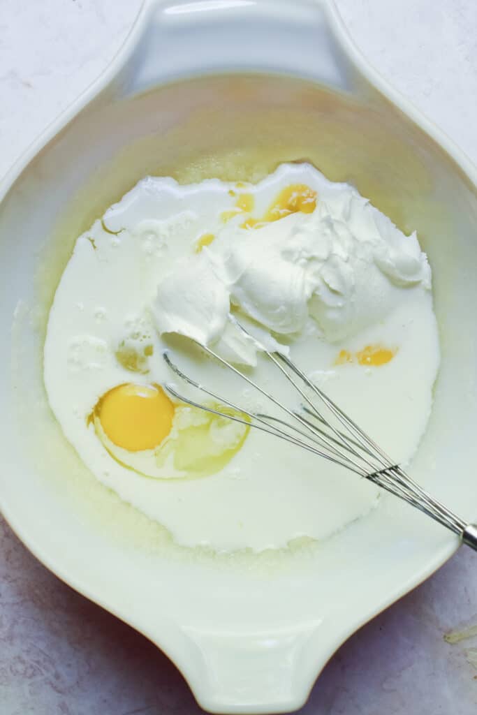 The sour cream and milk are added to the bowl.