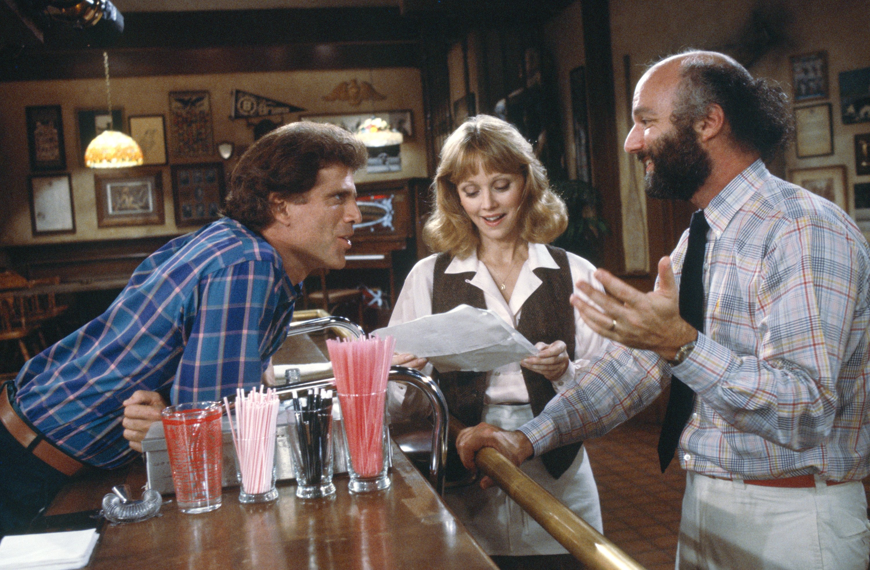 Ted Danson, Shelley Long, and James Burrows in Cheers (1982)