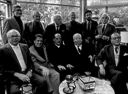 Directors Group, Nov. 1972. George Cukor Hosts a party for Luis Bunuel. Back Row from left: Robert Mulligan, William Wyler, George Cukor, Robert Wise, Jean-Claude Carriere, and Serge Silverman.  Front Row from left: Billy Wilder, George Stevens, Luis Bunuel, Alfred Hitchcock, and Rouben Mamoulin.