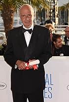 Producer Alain Sarde poses with The Jury Prize awarded to director Jean-Luc Godard who was absent from the ceremony at the Palme D'Or Winners photocall during the 67th Annual Cannes Film Festival on May 24, 2014 in Cannes, France. 