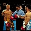 Vince and Cesar get instruction from the ref (Darrel Foster), flanked by their trainers, played by Eloy Casados (left) and Henry G. Sanders (right).  Famed ring announcer, Michael Buffer stands behind the ref. 