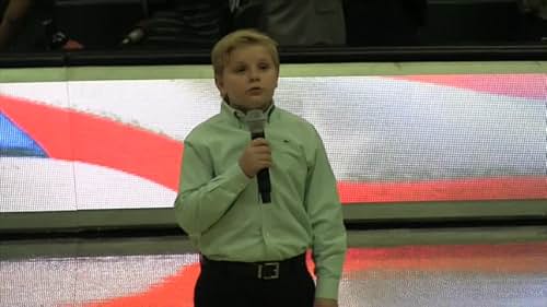 Brogan singing the National Anthem at college bb game