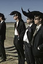 Sakke Järvenpää, Heikki Keskinen, Pimme Korhonen, Sakari Kuosmanen, Puka Oinonen, Matti Pellonpää, Mauri Sumén, Mato Valtonen, and Pekka Virtanen in Leningrad Cowboys Go America (1989)