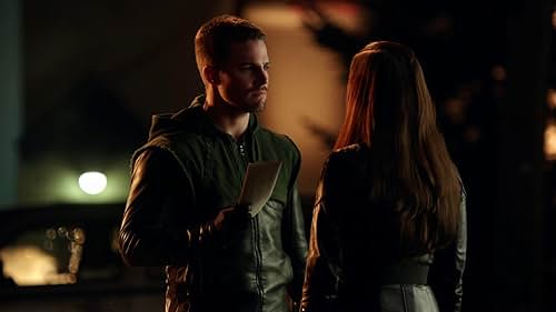 Stephen Amell and Jessica De Gouw in Arrow (2012)