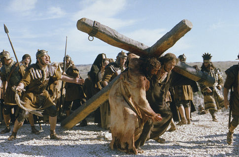  Simon of Cyrene (Jarreth Merz) helps Jesus (Jim Caviezel) carry his Cross.