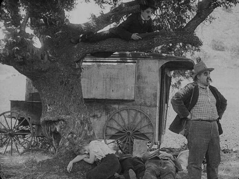 Charles Chaplin, Frank J. Coleman, and Edna Purviance in The Vagabond (1916)