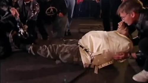 Mark Cannon secures Criss Angel into two strait jackets before hoisting him upside-down over Bourbon Street, New Orleans.