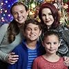 Priscilla Presley, Nina Thurmond, Trace Masters, and Hailey Harris in Christmas at Graceland: Home for the Holidays (2019)