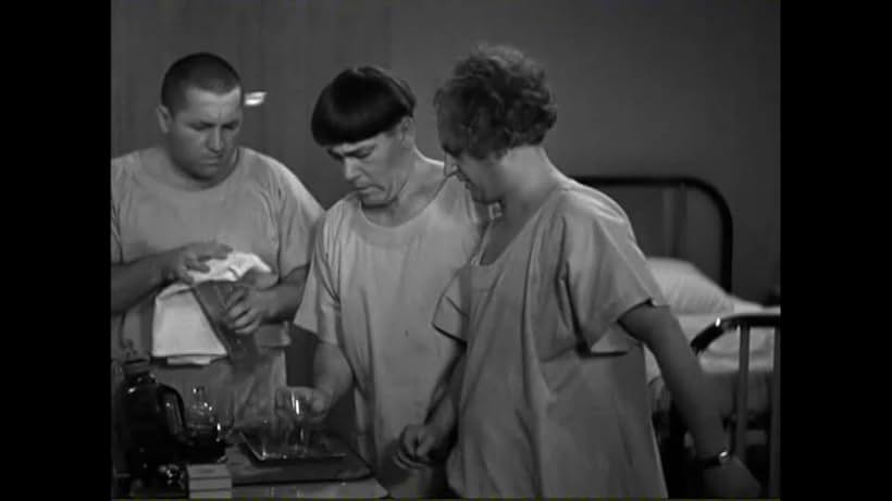 Moe Howard, Larry Fine, and Curly Howard in Men in Black (1934)