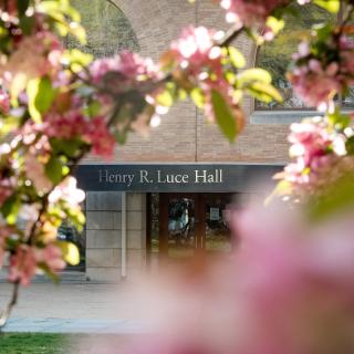 Entrance to Luce Hall seen through blooming trees