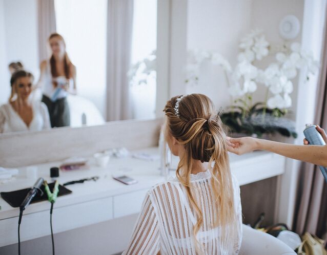 Bride getting her hair styled