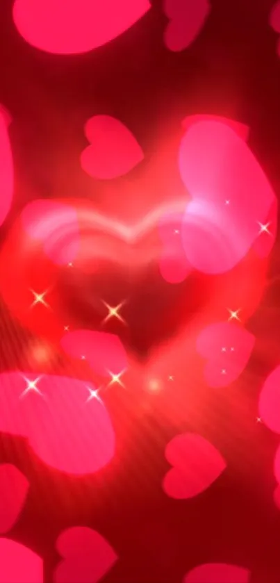 Glowing heart mobile wallpaper with red and pink hues and sparkling effects.