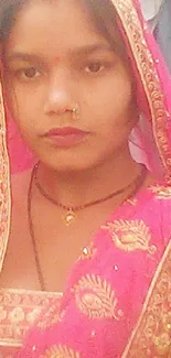 Mobile wallpaper of a woman in vibrant pink traditional attire.