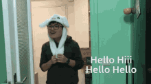 a man wearing a bunny hat is standing in front of a door that says hello hiii hello hello