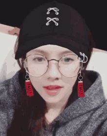 a woman wearing glasses and a hat that says ' love ' on it