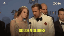 a man and a woman are standing in front of a microphone and the words golden globes are on the bottom