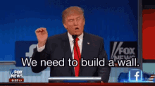 donald trump is giving a speech in front of a fox news sign